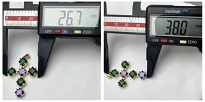 Detailed measurement of cross pendant with green and purple stones showing 38.0mm height