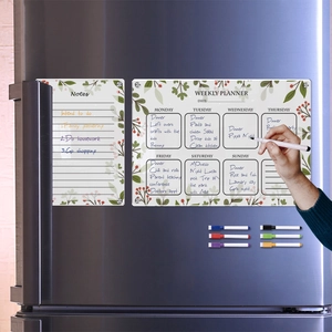 Hand writing on magnetic acrylic weekly planner and notes board set on a fridge
