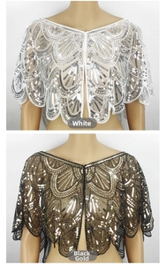 Detailed view of mesh capelet with intricate sequin embroidery and scalloped edges