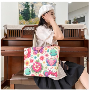 Detail of canvas tote bag featuring vibrant butterfly floral prints and sturdy handles