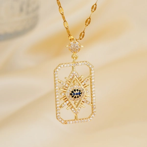 Detailed view of golden rectangle evil eye pendant with blue and clear zircon inlay