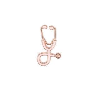 Detailed close-up of a stethoscope-shaped brooch with pink enamel and gold-plated metal