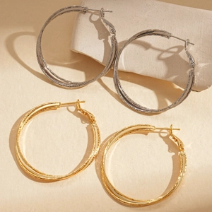 18k gold and silver plated double-layer crossover hoop earrings on minimalist background