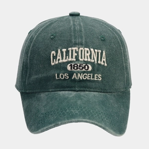 Close-up of vintage embroidered California 1850 text on dark green washed cotton cap