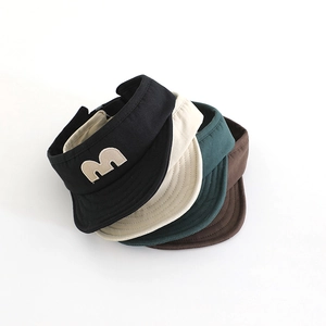 Stack of children's outdoor sun visors in various colors with an embroidered M letter logo