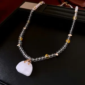 Elegant glass beaded necklace with a white translucent stone pendant on black leather