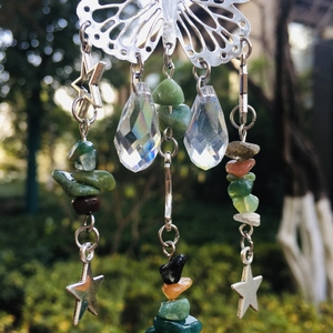 Detail of silver butterfly suncatcher with crystal prisms and green crushed stones