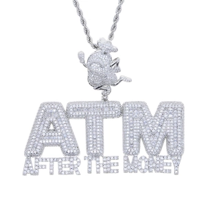Macro shot of silver ATM After The Money hiphop pendant with paved zircon stones