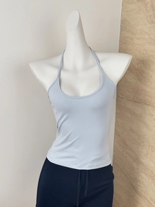 Detail of light blue halter neck knitted top showing slim fit and textured fabric