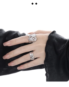 Close-up of S925 sterling silver leaf textured ring and irregular diamond band on hand