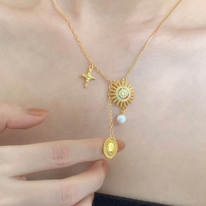 925 silver gold sun goddess necklace with pearl sun and cross charms on skin