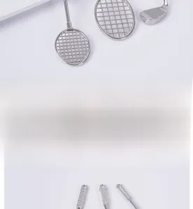 Detailed macro view of silver miniature badminton rackets and golf club toy models