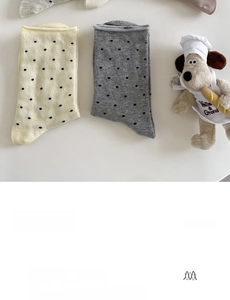 Macro detail of combed cotton mid-tube socks with elegant dots and wavy rolled edge texture