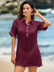 Detail view of burgundy linen shirt dress with button-up front and classic collar