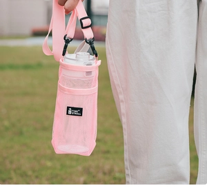 Pink mesh water bottle carrier with adjustable shoulder strap for outdoor travel use