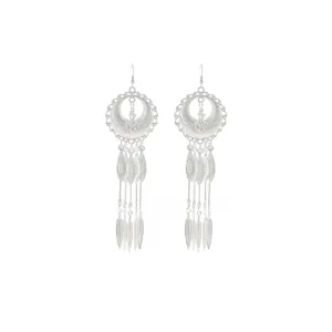 Detail view of Bohemian silver earrings with hollow circular patterns and long tassels