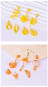 Flat lay of colorful acrylic earrings pendants in geometric and fan shapes for DIY crafts