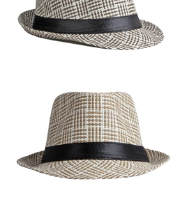 Detailed macro view of woven straw fedora hat featuring brown and white pattern texture