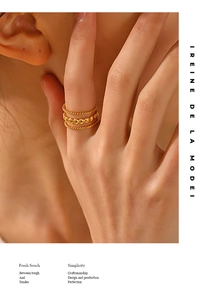 Detailed view of triple-layered 18K gold-plated beaded rings worn on a hand