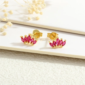 Close-up of 18K gold crown stud earrings featuring five pink marquise-cut gemstones