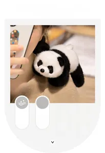 Detail of soft plush panda toy made of premium mink velvet held by hand in home setting