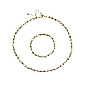 Close-up of gold-plated stainless steel beaded necklace and bracelet jewelry set