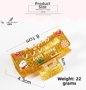 Detailed view of golden Christmas hair claw clip with Santa motif and 8.1cm size markings