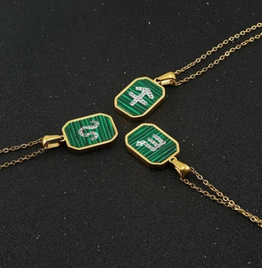 Macro shot of gold zodiac pendants with malachite texture and sparkling crystals