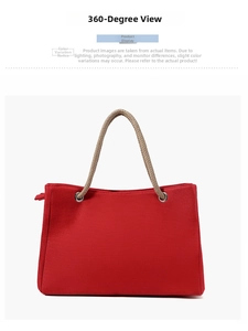 Detail view of red canvas tote bag with thick braided rope handles and zip closure