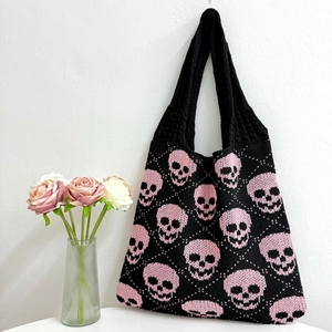 Knitted tote bag with pink skull patterns and wide shoulder straps for Halloween