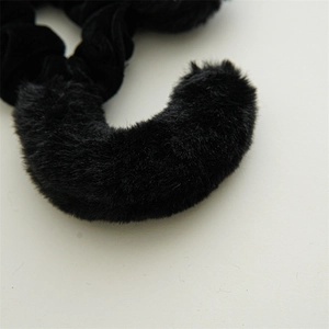 Detail of soft black plush fabric and fluffy faux fur texture for Halloween hair accessory