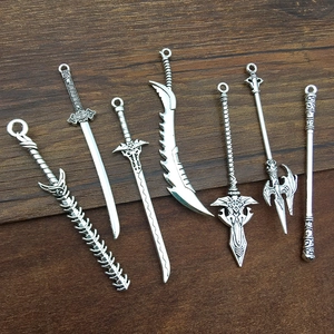 Detailed view of vintage silver alloy sword pendants with intricate carvings on wood