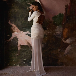 Elegant white mesh long sleeve dress with backless lace-up detail and flowing pleated skirt