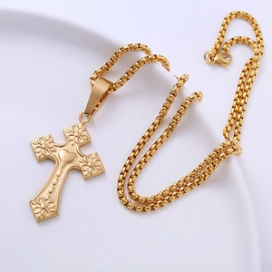 Gothic gold stainless steel heart pendant necklace with embossed flower on white tray