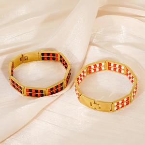 Close-up of 18K gold-plated double-row beaded bracelets with red and black stones