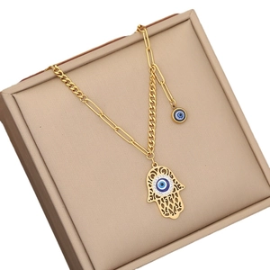 Golden Hamsa hand necklace with blue evil eye pendant and mixed Figaro paperclip chain