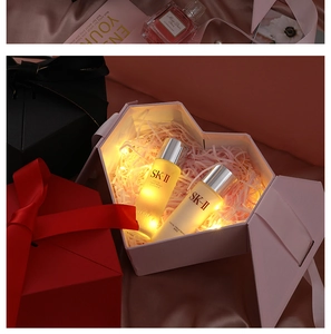 Macro detail of hexagonal pink gift box with warm LED lights and shredded raffia paper