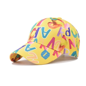 Detailed view of yellow cotton baseball cap with colorful gradient letter print