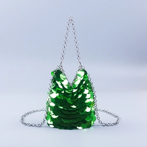 Detail of emerald green sequin handbag with luxury silver metal chain handles