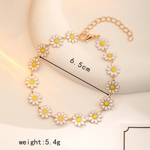 Elegant gold chain daisy bracelet with white enamel flowers and adjustable clasp link