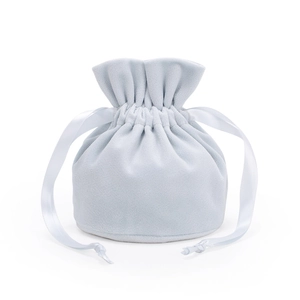 Detail of light blue velvet drawstring jewelry bag with soft texture and silk ribbons