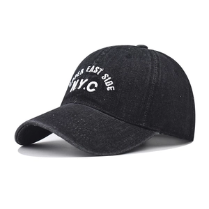 Close-up of N.Y.C white embroidery and stitching on washed denim baseball cap