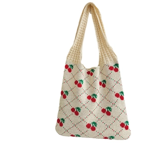 Beige knitted tote bag featuring red cherry patterns and green diamond embroidery textures