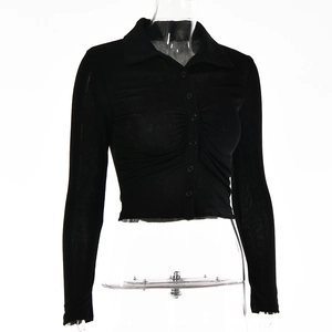 Close-up of black long-sleeved cropped cardigan with lapel collar and pleated button detail
