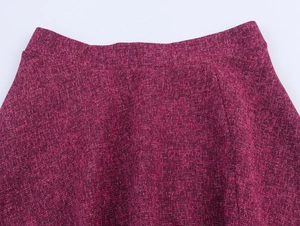 Detailed macro view of the wine red tweed skirt waist showcasing premium fabric texture