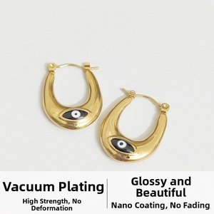 Detail of gold U-shaped earrings with black evil eye enamel and vacuum plating finish