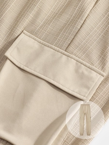 Close-up of khaki cargo pants showing ribbed fabric texture and stitched pocket detail