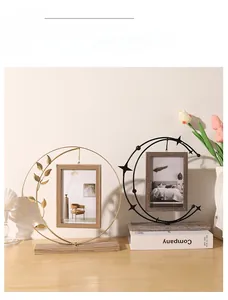 Detail of luxury metal photo frames with gold leaf and crescent moon artistic designs