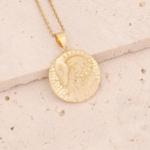 Detailed view of 18K gold plated Aries zodiac pendant necklace on a natural stone surface