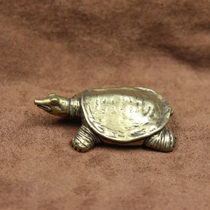 Detailed close-up of a solid copper turtle figurine with vintage texture and shell patterns